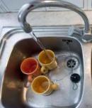sink-with-dishes-and-water-running