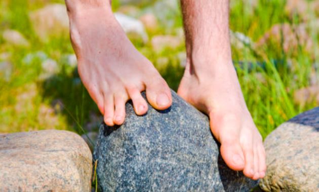 bare-feet-balancing-on-rock