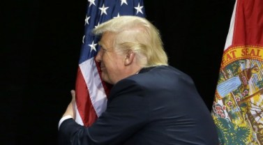 trumps_hugs_the_flag