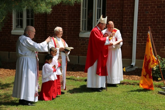 Bishop Brian consecrating Brandi's bench and rose garden